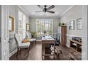 Bright office with large windows, plantation shutters, hardwood floors, and a ceiling fan at 17112 Courtside Landing Dr, Cornelius, NC 28031