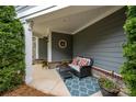 Inviting porch with comfortable seating, a stylish rug, and decorative plants, perfect for relaxing outdoors at 17112 Courtside Landing Dr, Cornelius, NC 28031
