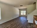 Open-concept living room with large window and vinyl flooring, perfect for entertaining at 2300 Grayson Pkwy, Monroe, NC 28110