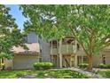 Charming condo exterior with mature trees and well-maintained landscaping at 2533 Stockbridge Dr, Charlotte, NC 28210