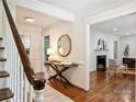 Elegant foyer with hardwood flooring, table, mirror and an opening into the living room at 2919 Wickersham Rd, Charlotte, NC 28211