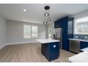 Bright kitchen featuring a center island, stainless steel refrigerator, and sleek modern design at 304 Cabarrus W Ave, Concord, NC 28025