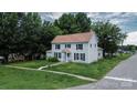 Two-story house featuring a classic design, surrounded by a well-maintained lawn, sidewalk and mature trees at 315 E Washington Ave, Bessemer City, NC 28016