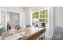 Well-lit office featuring a spacious wooden desk, comfortable chairs, and a large window with scenic views at 3734 Coleman Dr, Charlotte, NC 28215