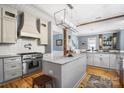 Bright kitchen with stainless steel appliances, an island with marble countertop, and hardwood floors at 420 S Cedar St, Lincolnton, NC 28092