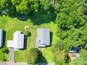Aerial view of the property highlighting its location, surrounding greenery, and a detached garage at 435 W Whitley St, Norwood, NC 28128