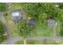 Aerial view of the property showing a backyard pool, spacious lot with mature trees, and surrounding neighborhood at 4633 Old Mill Rd, Gastonia, NC 28056