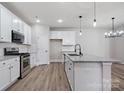 Modern kitchen with stainless steel appliances, granite countertops, and ample cabinet space, ideal for culinary enthusiasts at 6712 W Sugar Creek Rd, Charlotte, NC 28269