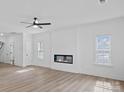 Spacious living room featuring a modern fireplace, large windows, and sleek flooring, perfect for relaxation and gatherings at 6712 W Sugar Creek Rd, Charlotte, NC 28269
