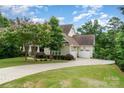 Beautifully landscaped home featuring a three-car garage and a circular driveway at 6873 Pine Moss Ln, Clover, SC 29710