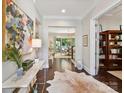 Grand foyer with hardwood floors, bright lighting, and a glimpse into the living and dining areas at 705 Vintage Creek Dr, Matthews, NC 28104