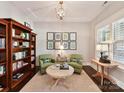Inviting living room features built-in bookcases, comfortable seating, and natural light from a large window at 705 Vintage Creek Dr, Matthews, NC 28104