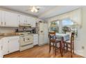 Eat-in kitchen features white cabinets and a large window with a view at 7304 Pebblestone Dr, Charlotte, NC 28212