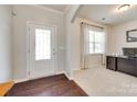 Bright entryway showcasing a stylish front door, beautiful floors, and a home office at 7930 Kelburn Ln, Charlotte, NC 28273