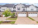 Charming townhome with brick accents, a two-car garage, and well-manicured landscaping at 9009 Odell Corners Nw Blvd, Concord, NC 28027