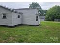 Exterior side view of the home shows gray vinyl siding and updated windows at 905 Klondale St, China Grove, NC 28023