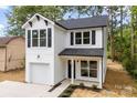 Charming two-story home with a white exterior, black shutters and a one-car garage at 105 Spring Garden Dr, Gastonia, NC 28052