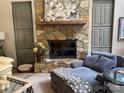 Cozy living room features a stone fireplace and ample seating at 1115 John Short Rd, Indian Land, SC 29707
