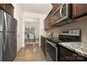 Modern kitchen with stainless steel appliances, granite countertops and dark wood cabinets at 124 Canada Dr # 45, Statesville, NC 28166