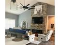 Beautiful living room featuring a stone fireplace, vaulted ceiling, and a ceiling fan at 133 Harbourtown Dr, Kings Mountain, NC 28086