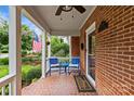 Relaxing front porch featuring blue chairs, a small table, and a view of the yard at 1729 Kensington Dr, Charlotte, NC 28205