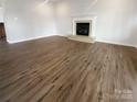 Spacious living room with a fireplace, and beautiful hardwood flooring throughout at 204 W Boyd St, Maiden, NC 28650