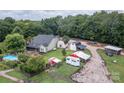 Aerial view of a home with in-ground pool, barns, sheds, trailers and equipment surrounded by trees at 2310 Gill Jordan Rd, Chester, SC 29706
