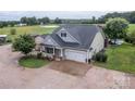 Aerial view of home featuring an attached garage, stone chimney, and well-manicured landscaping at 2310 Gill Jordan Rd, Chester, SC 29706