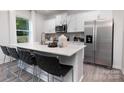 Bright kitchen with stainless steel appliances, a large island with seating, and sleek white cabinets at 2617 Goose Fair Rd, Maiden, NC 28650