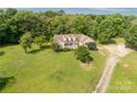 Charming home featuring dormer windows, a welcoming front porch and an expansive green lawn at 2818 Neill Rd, Lancaster, SC 29720