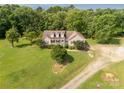 Charming home featuring dormer windows, a welcoming front porch and an expansive green lawn at 2818 Neill Rd, Lancaster, SC 29720