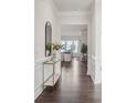 Bright entryway featuring hardwood floors and modern decor, leading to an open living space at 3128 Spring Iris Dr, Denver, NC 28037