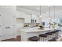 Modern kitchen featuring white cabinets, stainless steel appliances, and a spacious island with seating at 3128 Spring Iris Dr, Denver, NC 28037