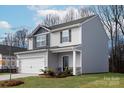 Stylish two-story home featuring a two-car garage, landscaped yard, and a welcoming front entrance at 3323 Burberry Dr, Gastonia, NC 28052