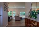 Open living space with wood floors, a comfortable sofa, bar seating, bright windows, and sliding glass doors to the deck at 4710 Old Pageland Marshville Rd, Monroe, NC 28112