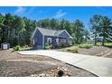 This charming home boasts a long driveway, lush landscaping, and beautiful curb appeal in a tranquil, wooded setting at 5016 Old Pine Ln, Cherryville, NC 28021