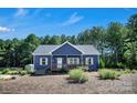 This appealing home has a cozy front porch, neat landscaping, and a well-maintained lawn perfect for relaxation at 5016 Old Pine Ln, Cherryville, NC 28021