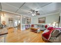 Open-concept living room with hardwood floors connecting to dining area at 504 Amon Ln, Pineville, NC 28134