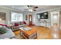 Comfortable living room featuring hardwood floors, large window, and stylish furnishings at 504 Amon Ln, Pineville, NC 28134