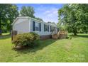 Well-maintained single-story home with light grey siding and a small deck at 6085 Faith Rd, Salisbury, NC 28146