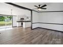 Bright open-concept living area with modern flooring and a view into the updated kitchen at 6085 Faith Rd, Salisbury, NC 28146