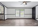 Bright, freshly painted living room with contemporary flooring and ceiling fan at 6085 Faith Rd, Salisbury, NC 28146