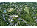 An aerial view of the property and surrounding neighborhood in Charlotte, North Carolina; including a golf course nearby at 6400 Morningsong Ln, Charlotte, NC 28269