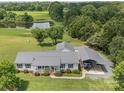 Sprawling property with a house, pond, car port, and lush green fields and trees at 714 Helms Efird Rd, Marshville, NC 28103