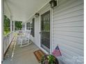 Welcoming front porch with rocking chairs, decorative lights, and seasonal décor at 714 Helms Efird Rd, Marshville, NC 28103