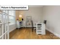 Bright office space with hardwood floors, a window with blinds, and white furniture at 7196 Sylvan Retreat Dr, Denver, NC 28037
