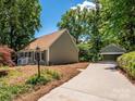 Charming single-Gathering home features a detached garage and is surrounded by mature trees at 7356 Terrace Dr, Charlotte, NC 28211