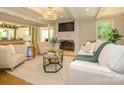 Bright living room featuring a fireplace, white sofas, and stylish decor at 7356 Terrace Dr, Charlotte, NC 28211