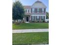 Beautiful two-story home with a well-manicured lawn, stone accents and shuttered windows at 85017 Newloch Ct, Lancaster, SC 29720