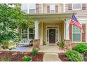 Welcoming front porch with stone pillars, comfortable seating, and tasteful decor creating a cozy entrance at 85017 Newloch Ct, Lancaster, SC 29720